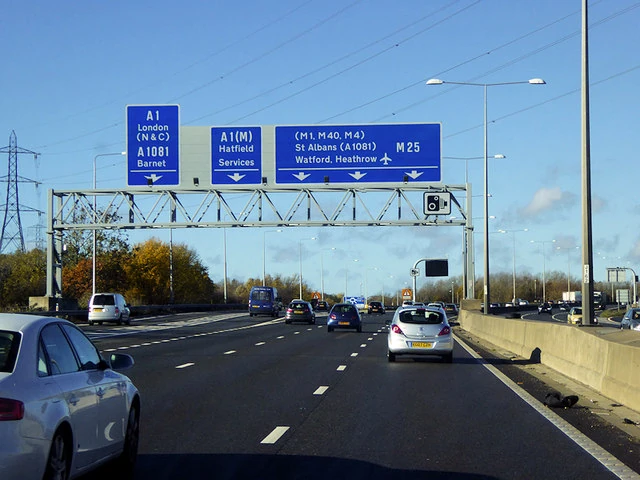 Road sign of the M25 in Hertfordshire showing St Albans, Watford, Hatfield, Barnet, London and Heathrow Airport.