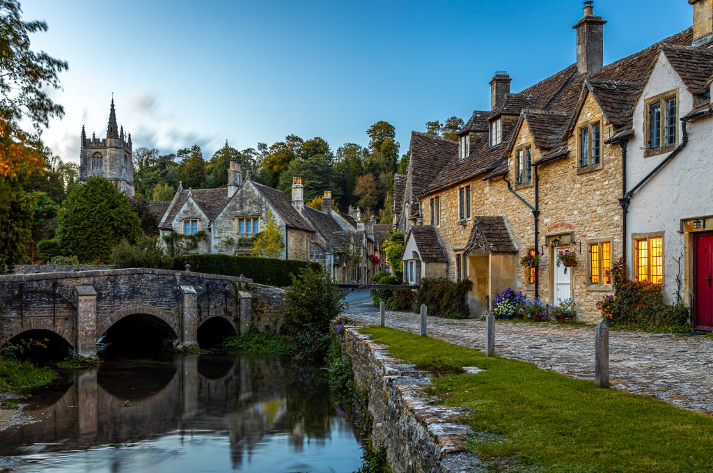 View of a river and bridge by a picturesque town in wiltshire
