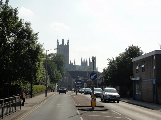 Private cars on Military Road, Canterbury. Canterbury Cathedral is seen in the background.