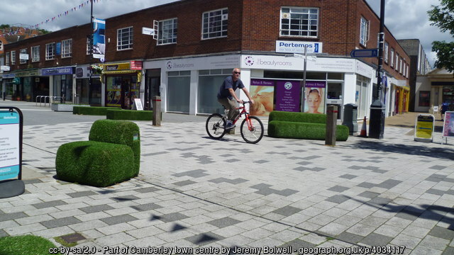 Camberley town square, a cyclist riding through