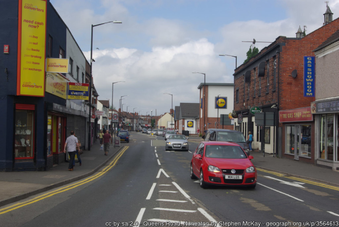 Nuneaton street with shops, cars and pedestrians