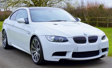White BMW car parked in driveway