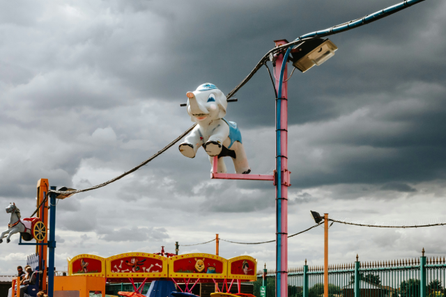 Canvey Island fairground, elephant statue on a lamp post, stormy sky background