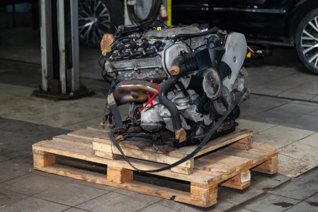 A car engine on a pallet having been removed