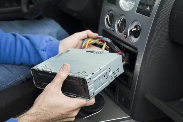 Car stereo being disconnected from centre console